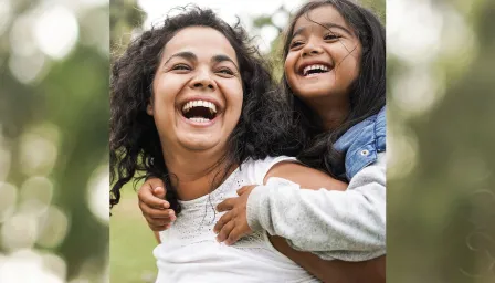 Daughter on moms back laughing