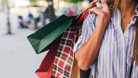woman holding multiple shopping bags 
