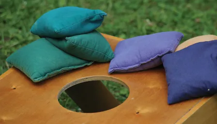 corn hole board with multiple bags landed on top