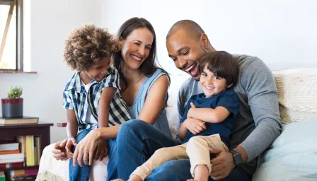 Family sitting on couch looking at each other