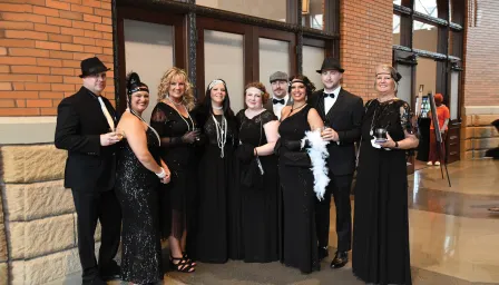 guests at 2023 groove gala dressed up in long dresses and suits