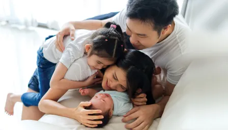 Family laying with new baby