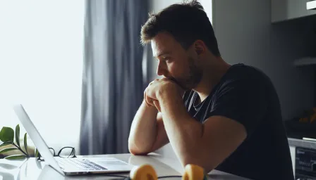 Man looking down at computer