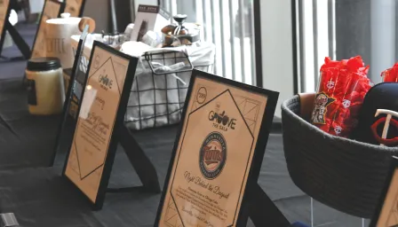 Silent auction items and signs on a table