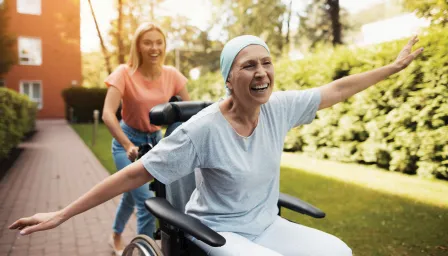 Woman outside happy being pushed in wheelchair